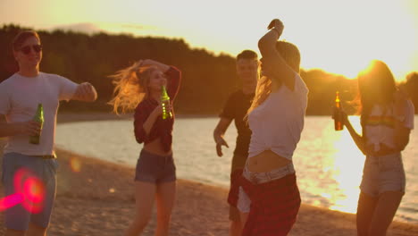 The-blonde-girl-is-dancing-with-nude-waist-on-the-open-air-party-with-beer.-It-is-crazy-and-hot-beach-party-with-the-best-friends-in-the-good-mood.